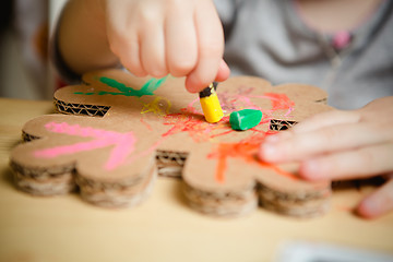 Image showing Little female baby painting with colorful paints