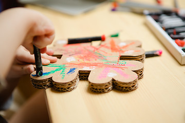 Image showing Little female baby painting with colorful paints