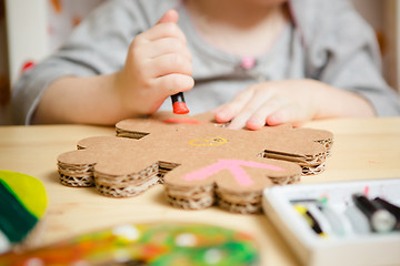 Image showing Little female baby painting with colorful paints