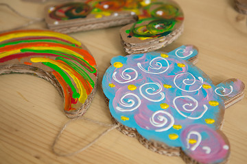 Image showing Colorful toys made of cardboard on a wooden table.