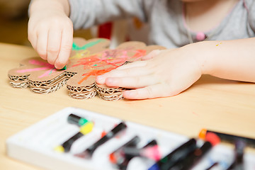 Image showing Little female baby painting with colorful paints