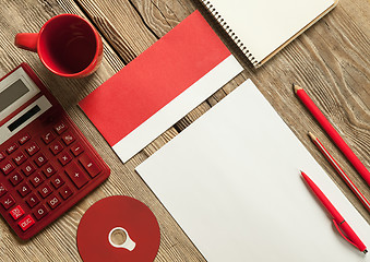 Image showing The mockup on wooden background with red calculator