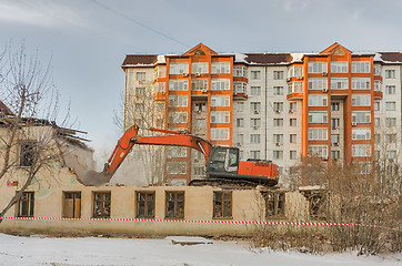 Image showing Demolition of a house with an orange digger