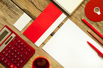 Image showing The mockup on wooden background with red calculator