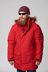 Image showing Man wearing red winter Alaska jacket  with fur hood on