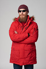 Image showing Man wearing red winter Alaska jacket  with fur hood on