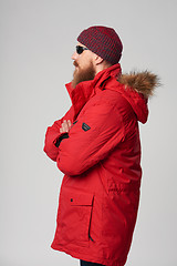 Image showing Man wearing red winter Alaska jacket  with fur hood on