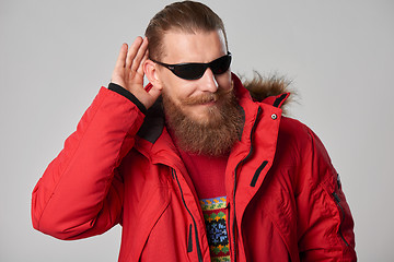 Image showing Man wearing red winter Alaska jacket  with fur hood on