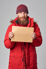 Image showing Man wearing red winter Alaska jacket  with fur hood on