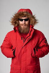 Image showing Man wearing red winter Alaska jacket  with fur hood on