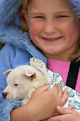 Image showing girl holding pup