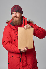 Image showing Man wearing red winter Alaska jacket  with fur hood on