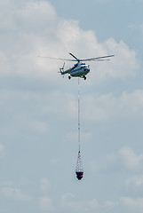 Image showing MI-8 helicopter flies for fire extinguishing