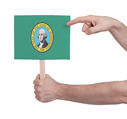 Image showing Hand holding small card - Flag of Washington