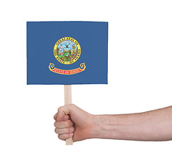 Image showing Hand holding small card - Flag of Idaho