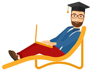 Image showing Graduate lying on chaise lounge with laptop.