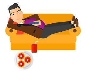 Image showing Man lying on sofa with junk food.