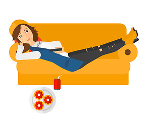Image showing Woman lying on sofa with junk food.