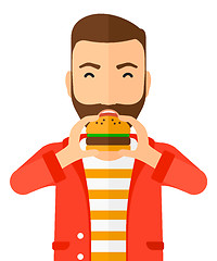 Image showing Man eating hamburger. 