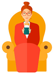 Image showing Woman sitting in chair with cup of tea.