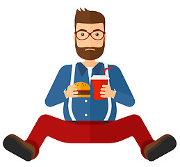 Image showing Man eating hamburger. 