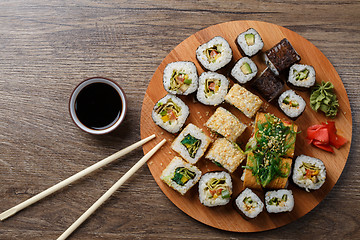 Image showing Sushi set at round wooden plate 