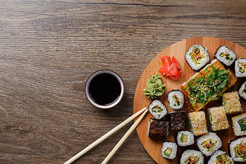 Image showing Sushi set at round wooden plate 