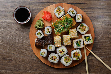 Image showing Sushi set at round wooden plate 
