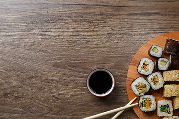 Image showing Sushi set at round wooden plate 