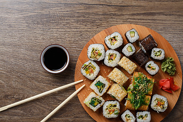 Image showing Sushi set at round wooden plate 