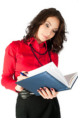 Image showing Pretty businesswoman standing with organizer diary