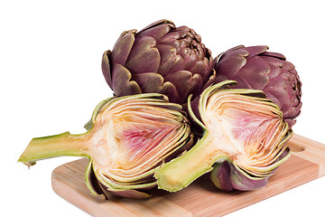 Image showing Fresh artichokes on a cutting board