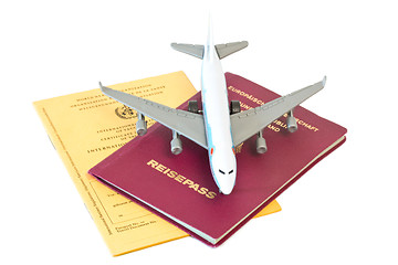 Image showing Toy plane on passport and vaccination card