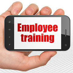 Image showing Education concept: Hand Holding Smartphone with Employee Training on display