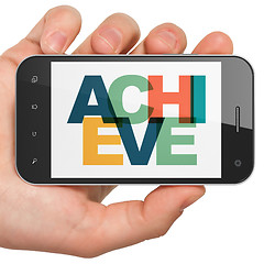 Image showing Business concept: Hand Holding Smartphone with Achieve on  display