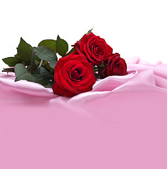 Image showing red roses on silk