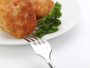 Image showing roasted cutlets with fork