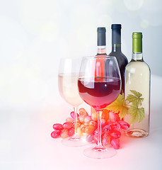 Image showing wineglass, bottles of wine and grapes