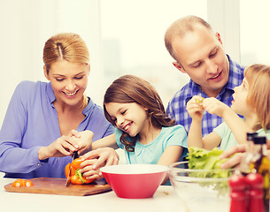 Image showing happy family with two kids making dinner at home