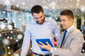 Image showing happy man with car dealer in auto show or salon