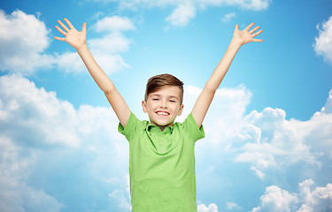 Image showing happy boy in polo t-shirt raising hands up