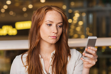 Image showing woman with smartphone and coffee at restaurant