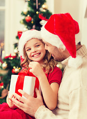 Image showing smiling father and daughter opening gift box