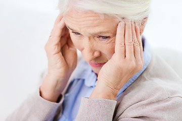 Image showing face of senior woman suffering from headache