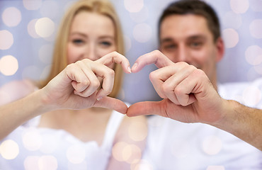 Image showing close up of couple showing heart with hands
