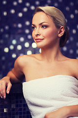 Image showing beautiful young woman sitting in bath towel