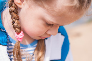 Image showing Upset girl turns away and hides her face