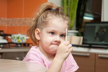 Image showing Girl with a funny looking angrily at a cotton swab