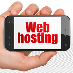 Image showing Web design concept: Hand Holding Smartphone with Web Hosting on display