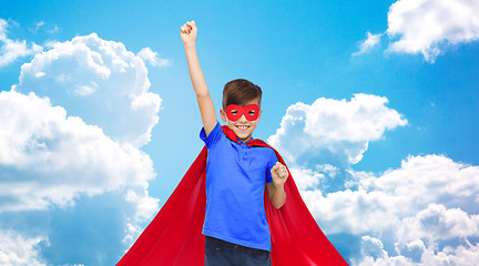 Image showing boy in red super hero cape and mask showing fists